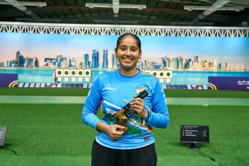 Young Indian pistol shooter celebrating victory with gold medal at ISSF World Cup Final 2025.