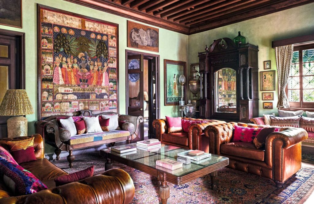Maximalist interior inside Sabyasachi Mukherjee Kolkata home featuring vibrant patterned wallpapers, bold colors, layered décor, and classic marble flooring.