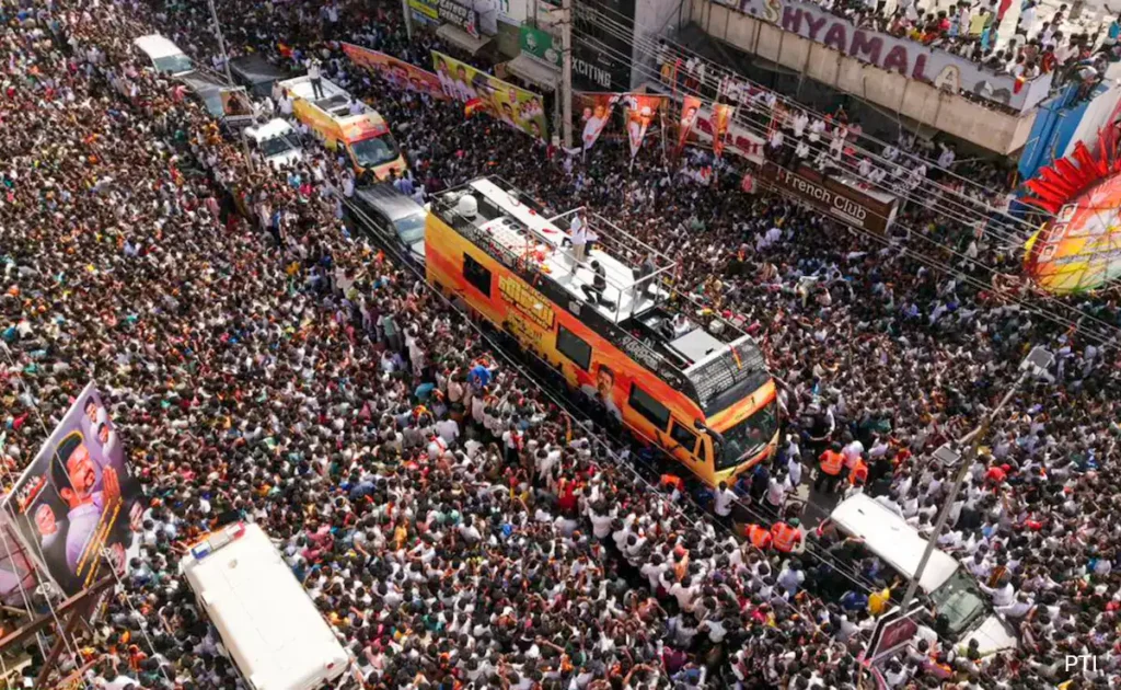 Medical personnel attending to a man at the TVK rally in Salem who collapsed and died, illustrating emergency care and hospital intervention.